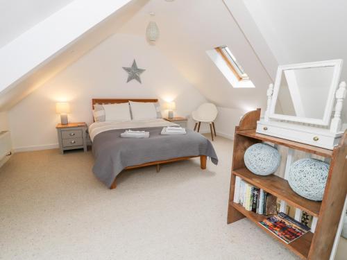 a bedroom with a bed and a tv in a attic at 2 Pant Heulog in Dyffryn