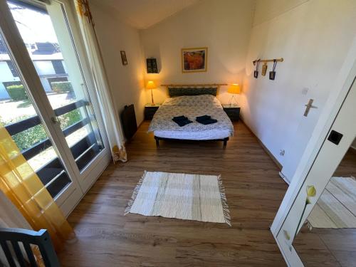 a bedroom with a bed and a large window at Port Ripaille, les grèbes 24 in Thonon-les-Bains