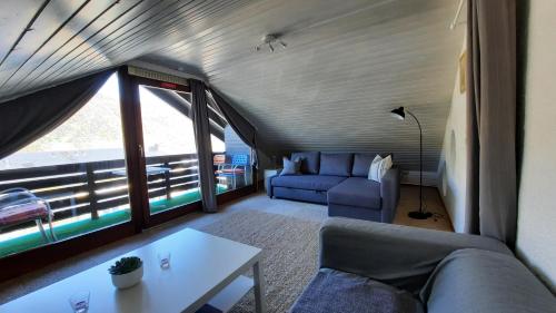 a living room with a couch and a table at Pension Schneider in Cochem