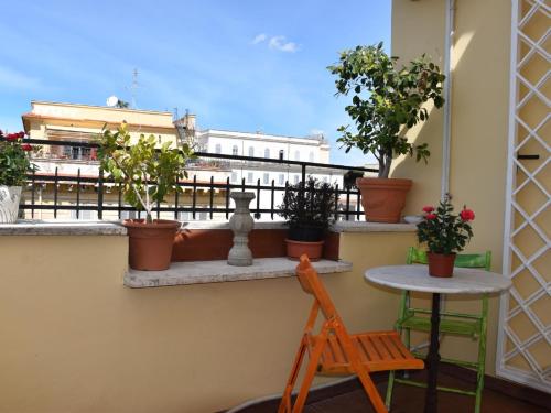 a balcony with potted plants and a table at LightHouse - Surfandwindsurferhouse in Anzio