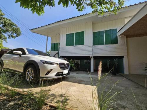 a car parked in front of a house at Simple Home บ้าน-บะ-ดาย in Ban Long O