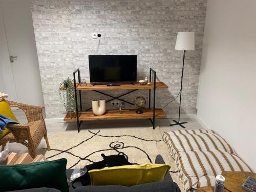 a living room with a television on a table at 5 Senses Hostel in Setúbal