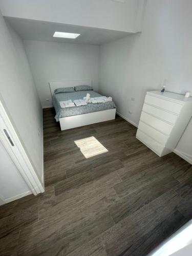 a bedroom with a bed and a wooden floor at NORD MILANO LUXURY APARTMENTS in Bresso