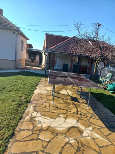 a ping pong table in the backyard of a house at Kuća u selu sa bilijar salom za aktivan odmor in Mionica