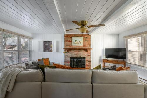a living room with a couch and a fireplace at Cozy Connecticut Beach House in East Haven