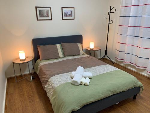 a bedroom with a bed with a stuffed animal on it at Chadstone Holiday E2 Villa in Oakleigh
