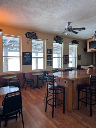 a kitchen with a bar with chairs and tables at White Sands Inn, Marina, Bar & Grill in Port Isabel