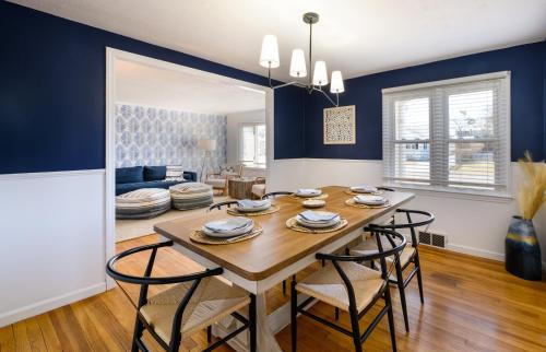 a dining room and living room with a table and chairs at Cozy Connecticut Beach House in East Haven