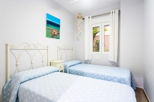 Benimagrellにある3 bedrooms appartement at El Campello Alacant 50 m away from the beach with sea view shared pool and furnished gardenのツインベッド2台 窓付きの部屋