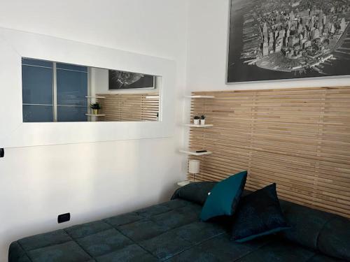 a bedroom with a bed and a picture on the wall at CasaPratti Pescara centro in Pescara