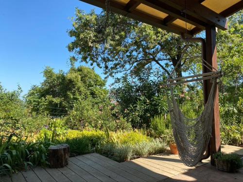 a hammock hanging from a pergola in a garden at Casa Sant Angelo in Pesaro