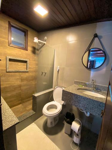 a bathroom with a toilet and a sink at Solar da Praia Pousada in Arraial do Cabo