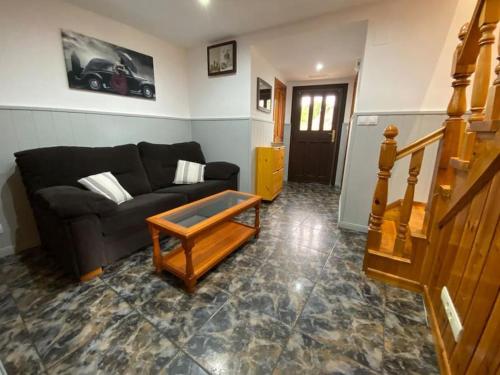 a living room with a couch and a coffee table at La Casa de Anita y José in Colunga