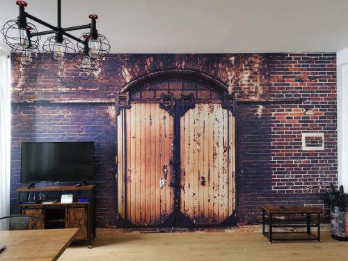 TV a/nebo společenská místnost v ubytování RivApartmentsDowntowN Urban