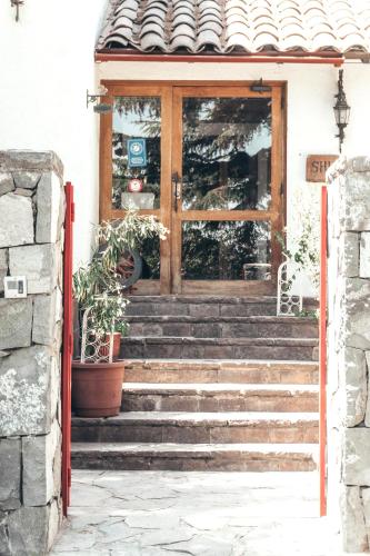 a door with stairs in front of a house at Casa Arrayán in Santiago