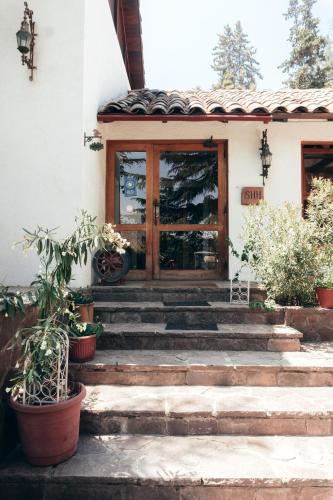 a front door of a house with potted plants at Casa Arrayán in Santiago