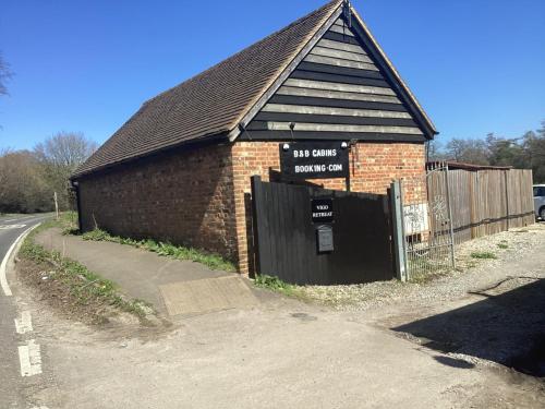 a brick building with a sign on the side of it at Vigo Retreat cabin 3 in Sevenoaks