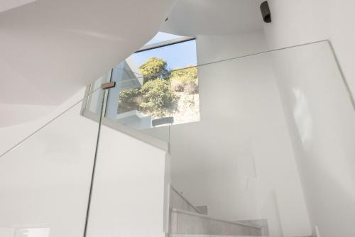 a glass house with a view of a tree at Euphoria Blue Villa στην περιοχή Ιξιά in Rhodes Town