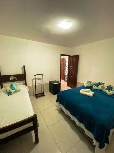 a bedroom with two beds in a room at Solar da Praia Pousada in Arraial do Cabo