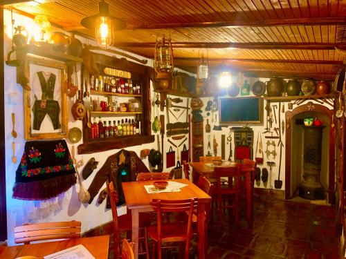 a restaurant with tables and chairs in a room at Etno selo Stanojevic in Boljevac