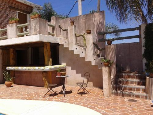 a building with a staircase with chairs and a table at Los Brunos Posada in Reconquista