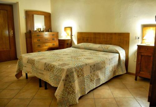 a bedroom with a bed with a table and a dresser at Casa Mimosa - appartamento vacanze sul Lago di Como in Sorico