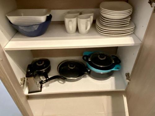 a cupboard with plates and bowls and dishes at Cumbre de Reñaca II in Viña del Mar