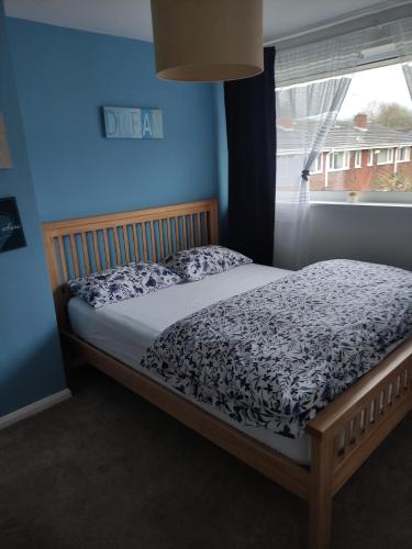 a bed sitting in a bedroom with a window at 3 bed house in Walsall, perfect for contractors & leisure & free parking in Walsall