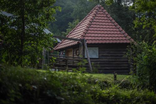 a log cabin with a red roof at GRAB ethno village and camp in Šćepan-Polje