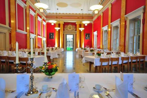 a dining room with tables and chairs in a building at Downing College in Cambridge