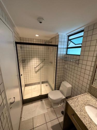 a bathroom with a shower and a toilet and a sink at Beach class muro alto in Porto De Galinhas