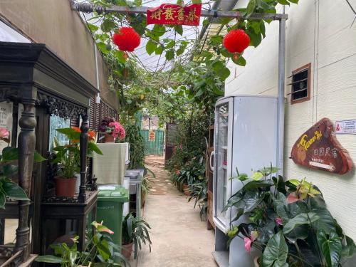 an alley with plants and flowers in a building at New Farmer Hut 2 in Brinchang