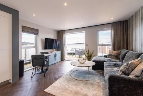 a living room with a couch and a table at Super High End 1 bed with Balcony - Central West Bridgford in Nottingham