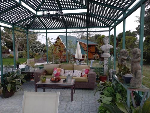 a pergola with a couch and a table in a yard at Casa Solis Monteprincipe in Boadilla del Monte