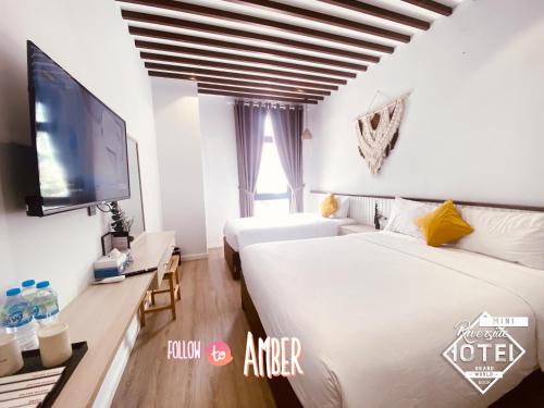 Postel nebo postele na pokoji v ubytování Riverside Mini Hotel Grand World Phu Quoc