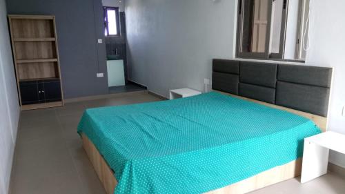 um quarto com uma cama grande e uma colcha azul em KG Villa em Grand Baie