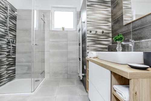 a bathroom with a shower and a sink and a tub at KORZO Lipno in Lipno nad Vltavou