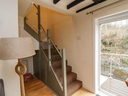 a staircase in a house with a window at Riverbank View in Whitby