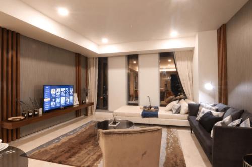 a living room with a couch and a tv at Tropicana The Residence KLCC in Kuala Lumpur