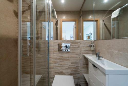 a bathroom with a shower and a toilet and a sink at Vilamoura Sun Aquamar 503 in Quarteira