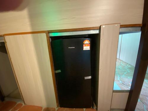 a black vending machine in the corner of a room at New Farmer Hut 2 in Brinchang