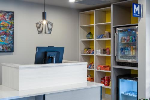 a cashier counter in a convenience store with a refrigerator at Microtel Inn & Suites by Wyndham Kanata Ottawa West in Kanata
