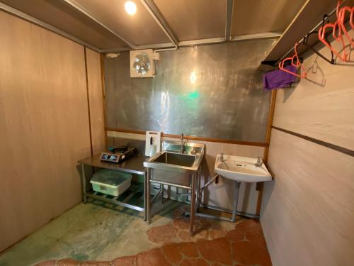a small bathroom with a sink and a mirror at New Famer Hut 2 in Brinchang
