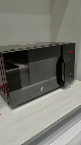 a microwave sitting on top of a shelf at VIGEVANO LA STAZIONE in Vigevano