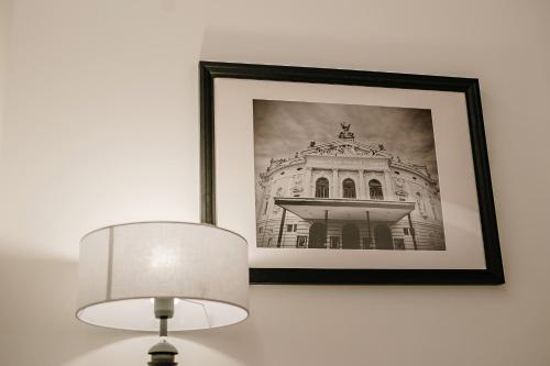 a picture of a building on a wall with a lamp at Operna klet Ljubljana in Ljubljana