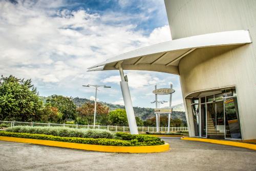 um posto de gasolina com um sinal em frente em Lidotel San Cristóbal em San Cristóbal