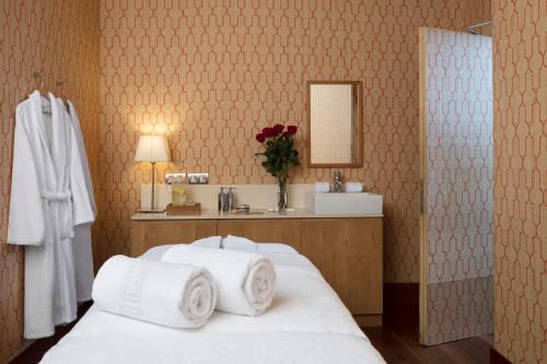 sypialnia z łóżkiem i ręcznikami w obiekcie URSO Hotel & Spa, a Small Luxury Hotel of the World w Madrycie