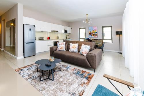 a living room with a couch and a table at Beachcove in Pereybere