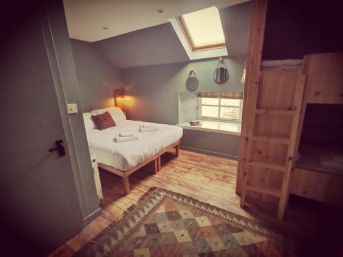 a small bedroom with a bed and a window at Comrie Croft in Crieff