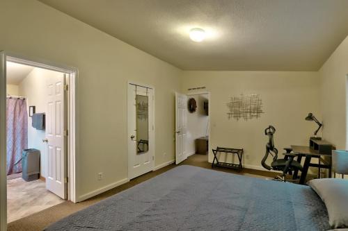 a bedroom with a bed and a desk in it at The Haire Haus in Nampa